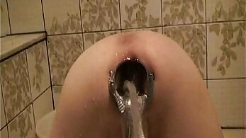 Tight asshole stretched by speculum for a water enema